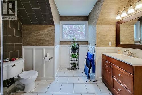 Bathroom with white tile flooring, white wainscoting, and textured wall coverings - 49 Ashwood Drive, Cambridge, ON - Indoor Photo Showing Bathroom