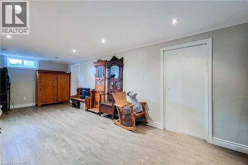 Spacious room featuring wood-finish flooring, recessed lighting, and a white bi-fold closet - 49 Ashwood Drive, Cambridge, ON - Indoor