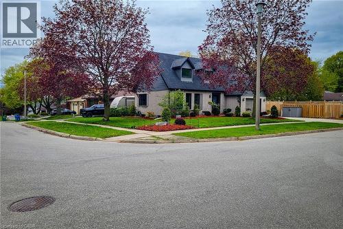 Light-colored brick exterior featuring a dark roofline with dormer windows - 49 Ashwood Drive, Cambridge, ON - Outdoor With Facade