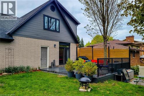 Rear exterior featuring a multi-tone facade with light brick and gray siding - 49 Ashwood Drive, Cambridge, ON - Outdoor With Exterior