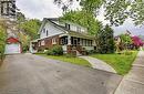 1 1/2 wide paved driveway, detached single car garage, side covered porch and interlocking brick walkway to the front door and covered screened porch - 72 Crescent Boulevard, Simcoe, ON  - Outdoor With Facade 