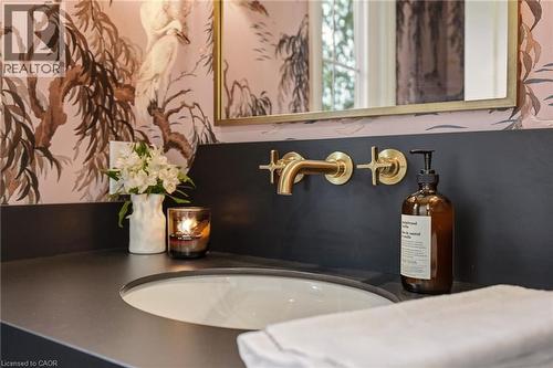 Contemporary vanity featuring a black countertop with an integrated sink - 3081 Balmoral Avenue, Burlington, ON - Indoor Photo Showing Bathroom