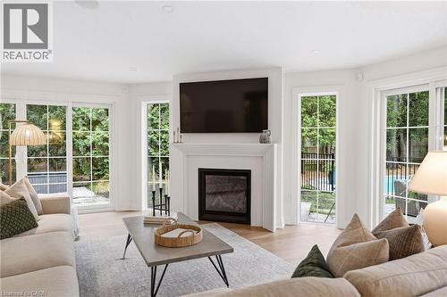 Living area featuring a white mantel fireplace, light wood-finish flooring, and recessed lighting - 3081 Balmoral Avenue, Burlington, ON - Indoor Photo Showing Living Room With Fireplace