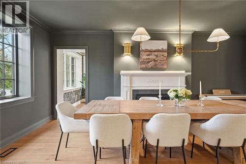 Dining area featuring wood-finish flooring, a white mantel, and a brass-tone chandelier - 3081 Balmoral Avenue, Burlington, ON - Indoor Photo Showing Dining Room