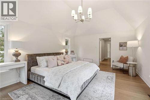 Vaulted ceilings featuring a contemporary chandelier, recessed lighting, hardwood flooring, and dual windows - 3081 Balmoral Avenue, Burlington, ON - Indoor Photo Showing Bedroom