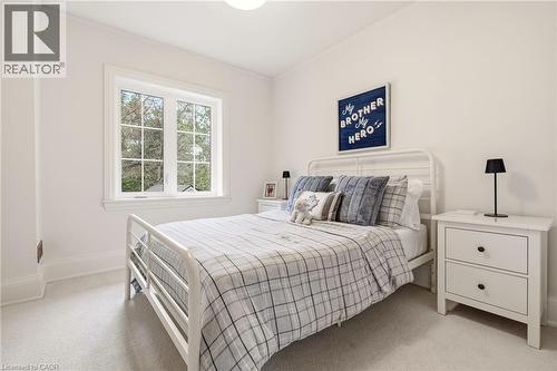 Light-filled room featuring a double-paned window, neutral wall paint, white trim, and light-colored carpeting - 3081 Balmoral Avenue, Burlington, ON - Indoor Photo Showing Bedroom