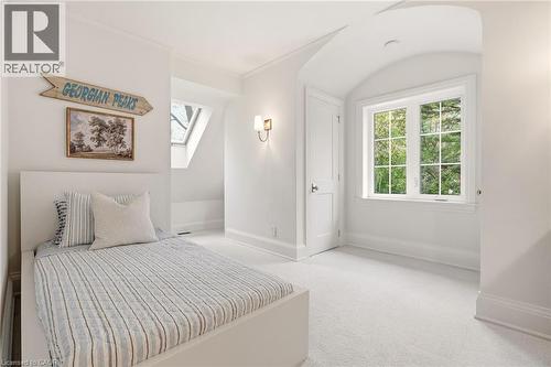 Bright room with a large grid window and additional skylight - 3081 Balmoral Avenue, Burlington, ON - Indoor Photo Showing Bedroom