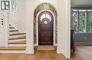 Arched entryway with a dark wood door featuring a circular glass insert - 3081 Balmoral Avenue, Burlington, ON  - Indoor Photo Showing Other Room 