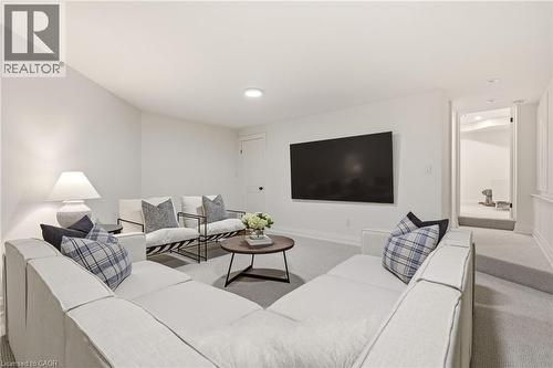 Spacious entertainment area featuring light gray carpeting and recessed lighting - 3081 Balmoral Avenue, Burlington, ON - Indoor Photo Showing Living Room