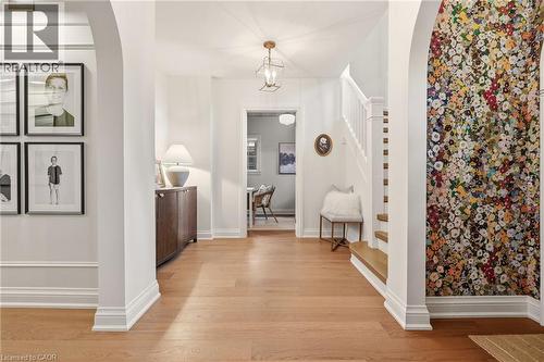 Entry foyer featuring wood-finish flooring, white trim, and arched doorways - 3081 Balmoral Avenue, Burlington, ON - Indoor Photo Showing Other Room