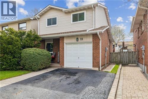 Brick and siding exterior featuring an attached single-car garage, asphalt driveway, and a paved walkway - 21 Lionshead Lookout, Brampton, ON - Outdoor