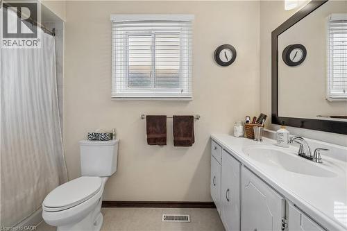 Bathroom featuring a single vanity with storage cabinetry, an integrated sink, and a chrome faucet - 21 Lionshead Lookout, Brampton, ON - Indoor Photo Showing Bathroom