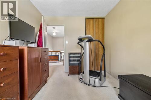 Carpeted flooring extending into a hallway with a visible railing - 21 Lionshead Lookout, Brampton, ON - Indoor