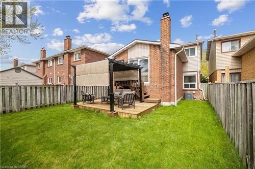 Expansive backyard featuring a lush lawn, wooden privacy fencing, and a multi-level deck - 21 Lionshead Lookout, Brampton, ON - Outdoor With Deck Patio Veranda