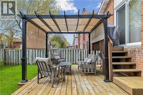 Spacious wood-finish deck featuring a black pergola with a retractable fabric canopy - 21 Lionshead Lookout, Brampton, ON - Outdoor With Deck Patio Veranda With Exterior