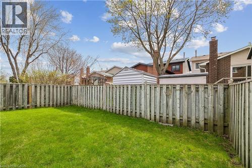 Expansive green lawn defined by a privacy fence, with mature trees providing natural shading - 21 Lionshead Lookout, Brampton, ON - Outdoor