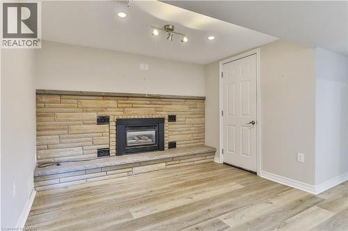 Stone-clad fireplace with a raised hearth and integrated firebox - 38 Dunkirk Drive Unit# B, Hamilton, ON - Indoor With Fireplace