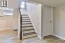 Staircase featuring dark wood newel post and railings, white risers, and dark treads - 38 Dunkirk Drive Unit# B, Hamilton, ON  - Indoor Photo Showing Other Room 