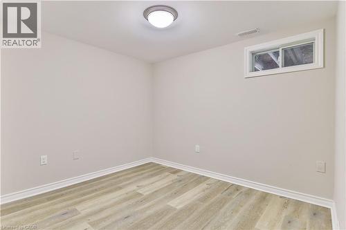 Light-toned wood-finish flooring complements neutral walls - 38 Dunkirk Drive Unit# B, Hamilton, ON - Indoor Photo Showing Other Room