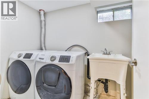 Dedicated laundry area featuring a utility sink, a window, and light-colored walls - 38 Dunkirk Drive Unit# B, Hamilton, ON - Indoor Photo Showing Laundry Room