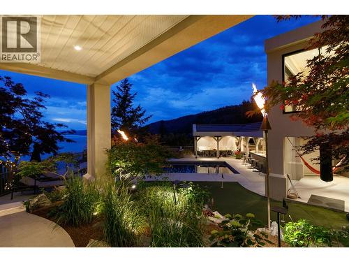 Evening under the covered Terrace with big views and gardens - 228 Caliburn Court, Kelowna, BC - Outdoor