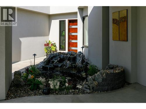 7 water fall fish pond at entrance - 228 Caliburn Court, Kelowna, BC - Outdoor With Exterior