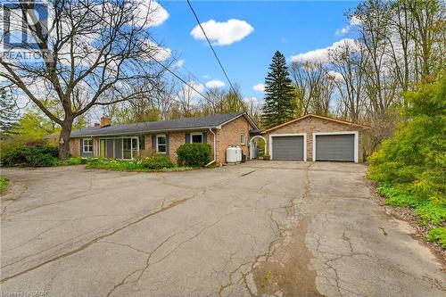Brick exterior residence featuring a screened porch and a two-car garage - 10 Huisman Lane, Hamilton, ON 