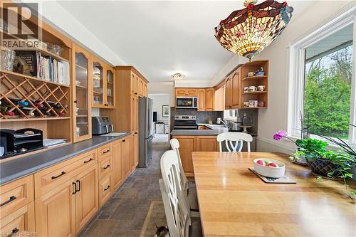 Light wood cabinetry with integrated wine rack and glass-front display cabinets - 10 Huisman Lane, Hamilton, ON 