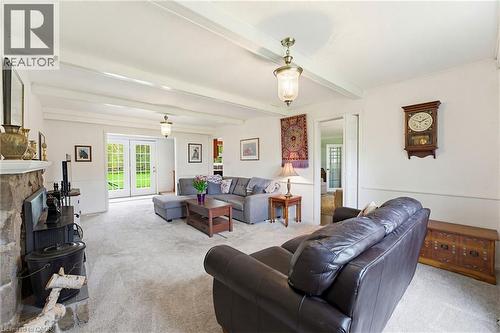 Living room featuring exposed ceiling beams and light-toned carpeting - 10 Huisman Lane, Hamilton, ON 