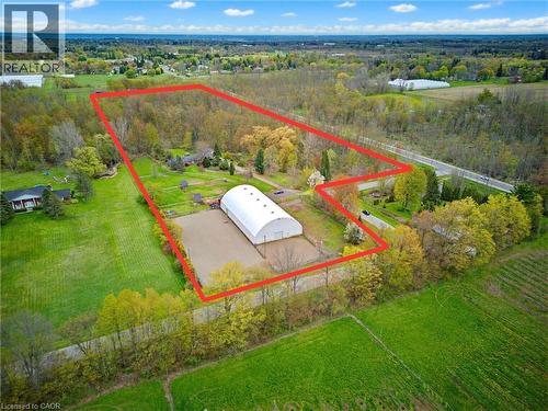 Expansive property featuring a large riding arena, extensive wooded areas, open fields, and direct road frontage - 10 Huisman Lane, Hamilton, ON 