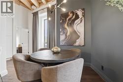 Exposed wooden ceiling beams complimenting dark wood-finish flooring - 