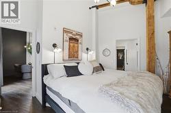 High ceilings featuring exposed wood beams and industrial-style lighting - 
