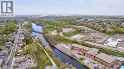 Aerial perspective showcasing a river, a bridge, and surrounding urban and green spaces - 