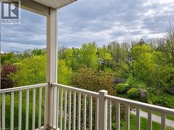 Balcony with white baluster railing and verdant treetop scenery - 