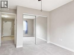 Room with neutral wall paint and light-colored carpeting - 