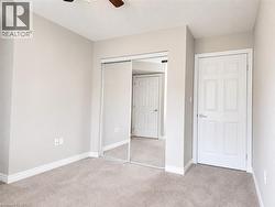 Carpeted interior room with light neutral wall paint - 