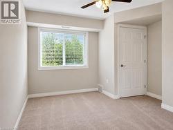 Room featuring wall-to-wall carpeting, neutral painted walls, and white trim - 