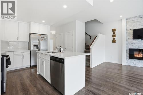 234 Brighton Gate, Saskatoon, SK - Indoor Photo Showing Kitchen With Fireplace With Stainless Steel Kitchen