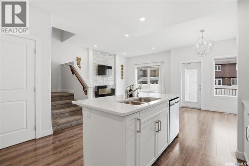 234 Brighton Gate, Saskatoon, SK - Indoor Photo Showing Kitchen With Fireplace With Double Sink