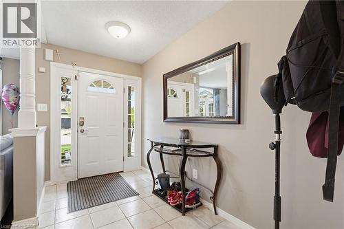 Entryway with white panel door featuring an arched window, flanked by sidelight windows and a transom - 47 Hannah Crescent, Hamilton, ON - Indoor Photo Showing Other Room