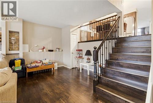 Dark wood-finish flooring throughout the main level - 47 Hannah Crescent, Hamilton, ON - Indoor Photo Showing Other Room