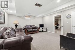Carpeted recreation room with recessed lighting and a drop ceiling - 