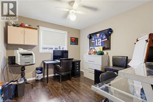 Room featuring wood-finish flooring, a ceiling fan with integrated lighting, and a window with a roller blind - 47 Hannah Crescent, Hamilton, ON - Indoor Photo Showing Office
