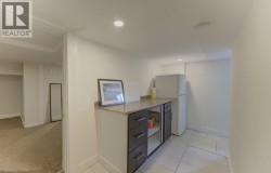 Built-in cabinetry with a stone-finish countertop, recessed lighting, and tile flooring - 