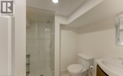 Glass-enclosed shower with tiled walls and a white subway tile floor - 