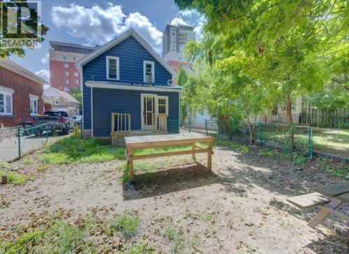 Two-story exterior with dark blue siding, white trim, and a rear deck - 10 Marshall Street, Waterloo, ON 