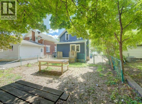Rear exterior with a wooden deck and a chain link fence - 10 Marshall Street, Waterloo, ON 