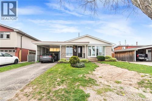 Brick exterior with a prominent bay window, featuring a covered carport and an additional detached carport - 112 Nash Road S, Hamilton, ON - Outdoor