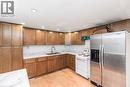 Kitchen featuring light wood-finish cabinetry, white countertops, stainless steel refrigerator, white range, and recessed lighting - 112 Nash Road S, Hamilton, ON  - Indoor Photo Showing Kitchen 
