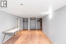 Spacious room featuring light wood-finish flooring, recessed lighting, and pale gray panel walls - 112 Nash Road S, Hamilton, ON  - Indoor Photo Showing Other Room 